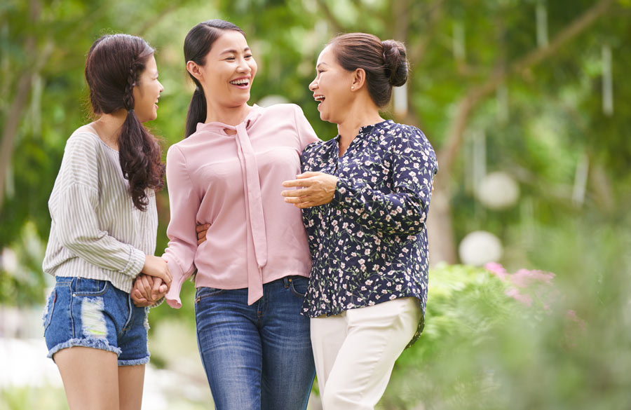 Three generations of Vietnamese women laughing together